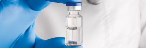 Life Sciences Valor vial held by pharmaceutical researcher