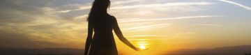 this is an image of a silhouette of a women in front of a sunset 
