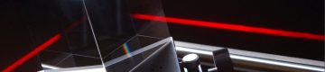 Red laser beam shoots at right angle through optic component