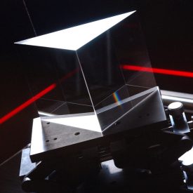 Red light beam shoots at right angle through optic component