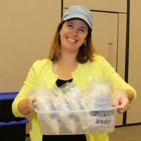 ​Plant Manager Michele Holbrook delivers meals to the meal sealing station.