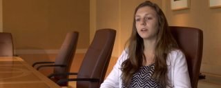 Closeup of Cassandra, a Corning intern, seated in conference room