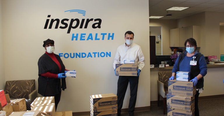 People holding boxes of surgical masks