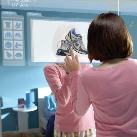 Woman uses large touchscreen display embedded in bedroom closet door